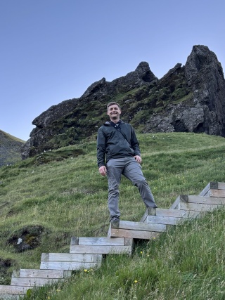 McKenzie Schwartz standing on steps in front of jagged rock formation