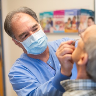 Doctor examines a nose of a patient.