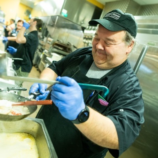 A chef prepares a dish in the hospital kitchen.