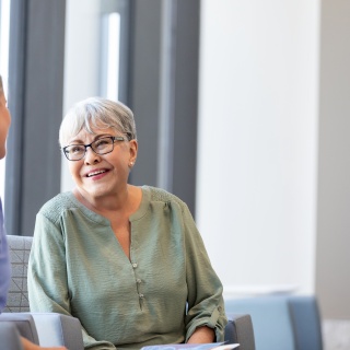Adult patient speaking with provider at medical office.