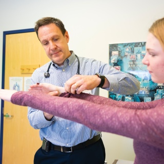 University of Vermont Medical Center Endocrinologist works with a patient during a check up.