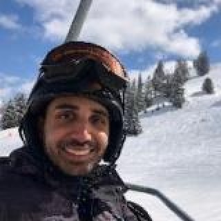 Naiim Ali, MD, FRCPC on a ski lift
