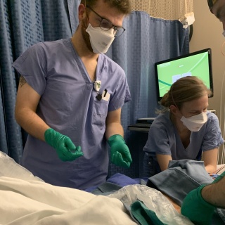 Luke Wohlford, MD with another resident working on a patient