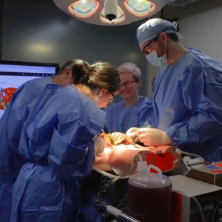Surgery residents operating in simulation lab