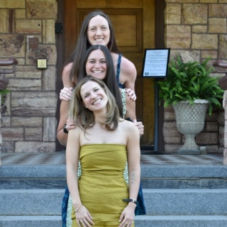 Group photo of three female OBGYN residents standing outside on the stairs.