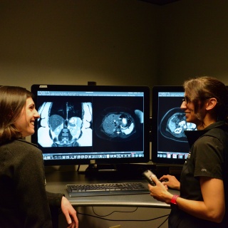 Two Diagnostic Radiology residents consulting in front of x-ray images