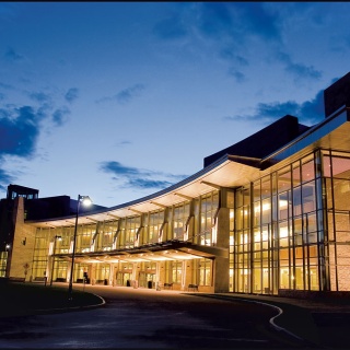The UVM Medical Center main entrance glows in the night sky.